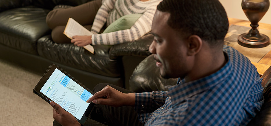 Husband looking at Consumers Energy bill